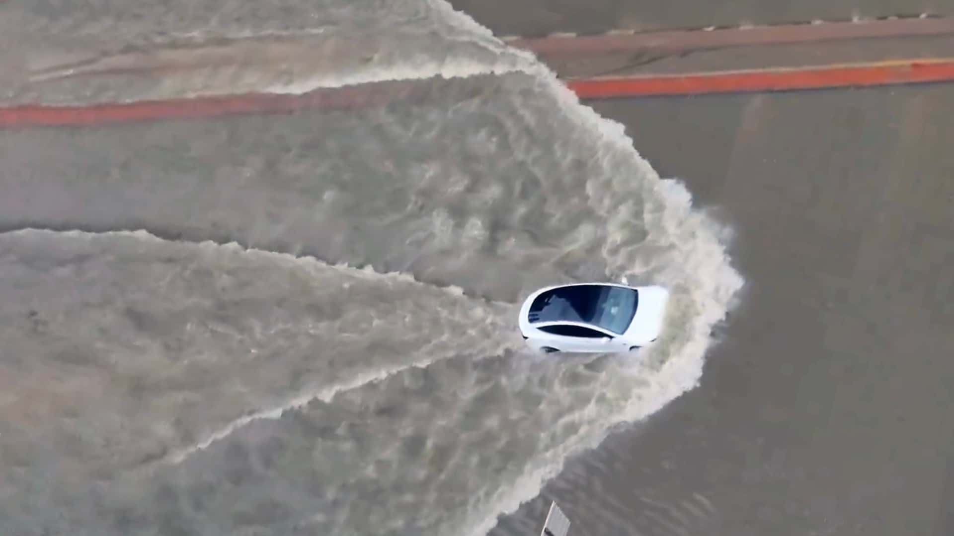 Watch A Tesla Model 3 And Porsche Taycan Drive Down Flooded Streets In Dubai