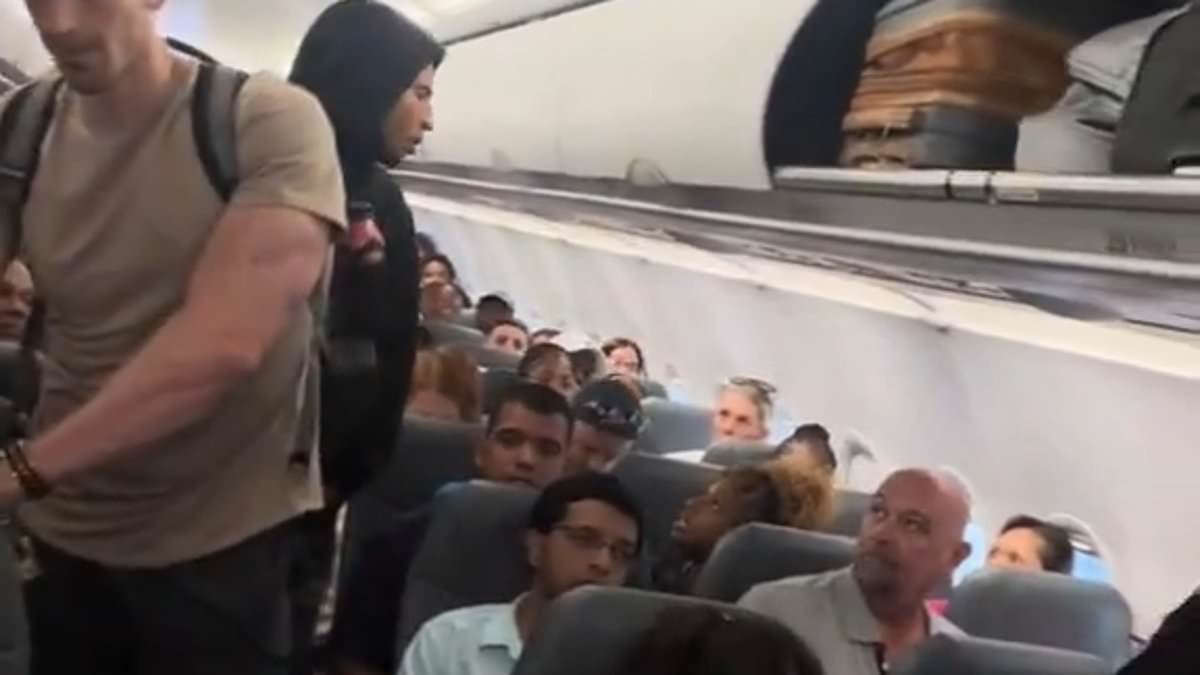 Ugly spat breaks out aboard Frontier Airlines flight to Atlanta as man and woman taunt each other for bizarre reason: 'Show me a band!'