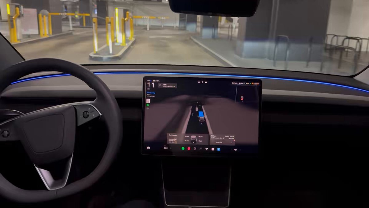 RT by @elonmusk: FSD v14 enters the Century City parking garage, pulls up to the ticket dispenser, waits for me to take a ticket then pulls into the garage and finds a spot. Insane. pic.