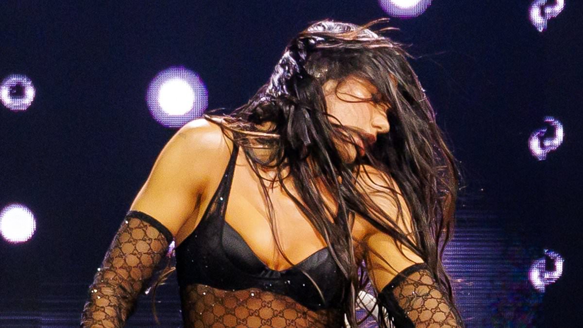 Dua Lipa sets pulses racing in stockings and suspenders as she slips into an array of sultry stage outfits while performing in LA