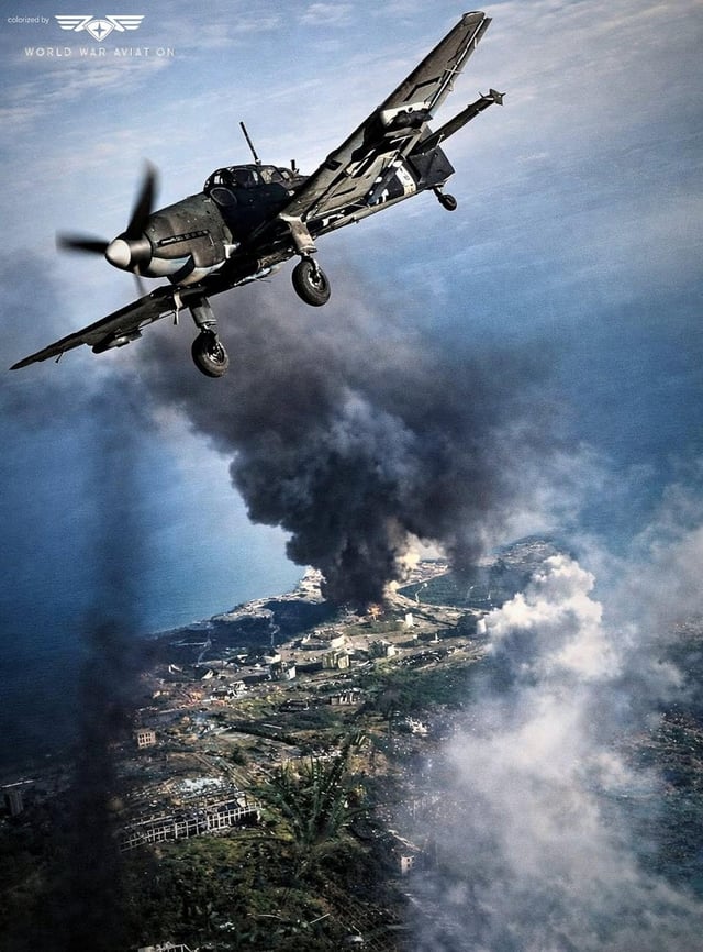 German Ju-87D Stuka dive bomber flies over the burning ruins of Stalingrad. 1942.[1080 × 1463]