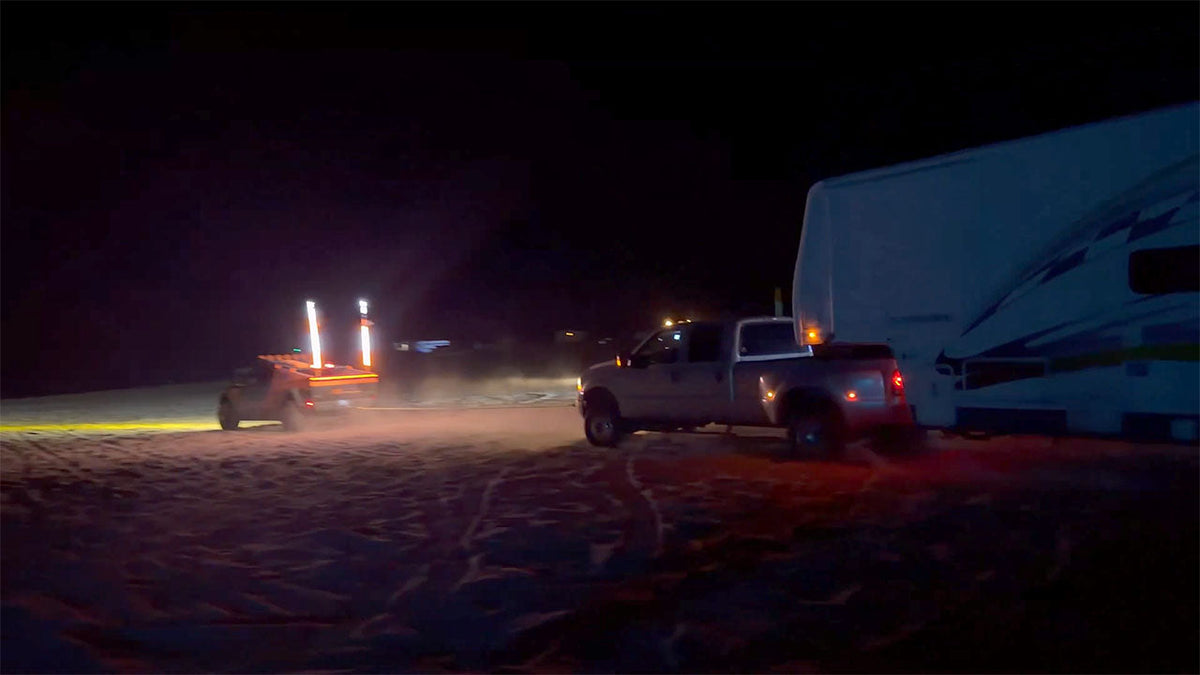 Cybertruck pulls Ford F-350 with a large trailer out of deep sand (video)