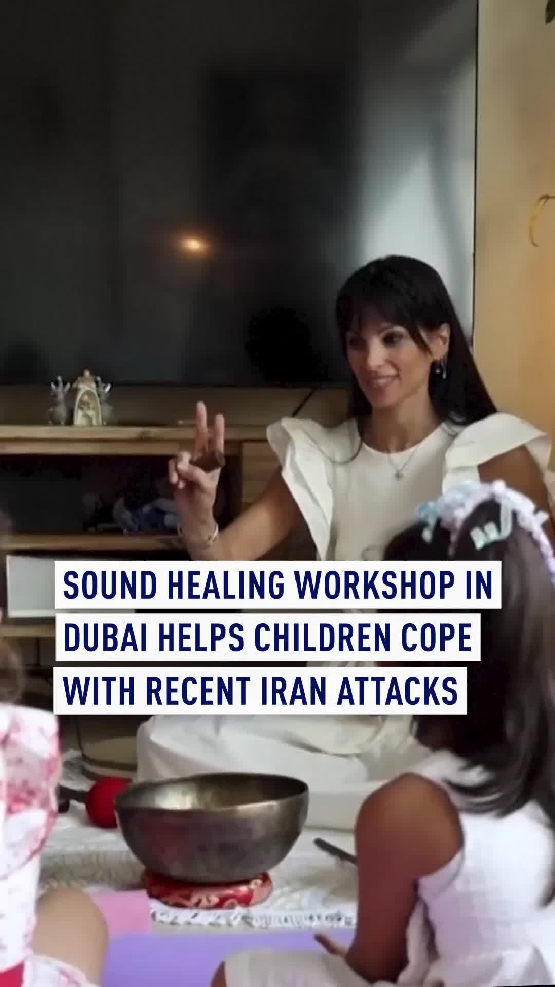 A Dubai-based art therapist provided a free sound healing and breathing workshop at her home to help children manage stress and anxiety after recent Iranian missile and drone attacks. Joy Najm used singing bowls, chimes, and an ocean drum to create soothing tones while guiding a small group through mindfulness exercises, combining breathing, meditation, and drawing. Children quietly closed their eyes, repeated positive affirmations, and then expressed themselves through drawing. Najm emphasized that the session aimed to create a feeling of safety and that therapy should be accessible to everyone, not a luxury. Parents said the activities helped their children disconnect from outside tensions
