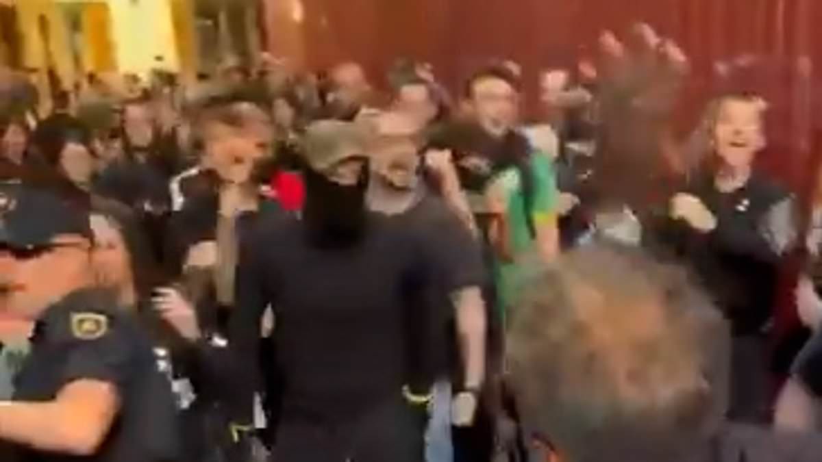 Violence erupts between right and left-wing protesters in Spanish city days after socialist government approved plans to give 500,000 migrants legal status